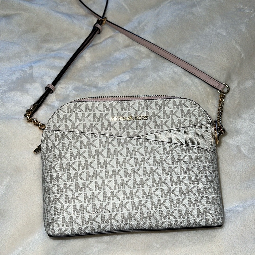 White Michael Kors purse with pink accents and gold hardware